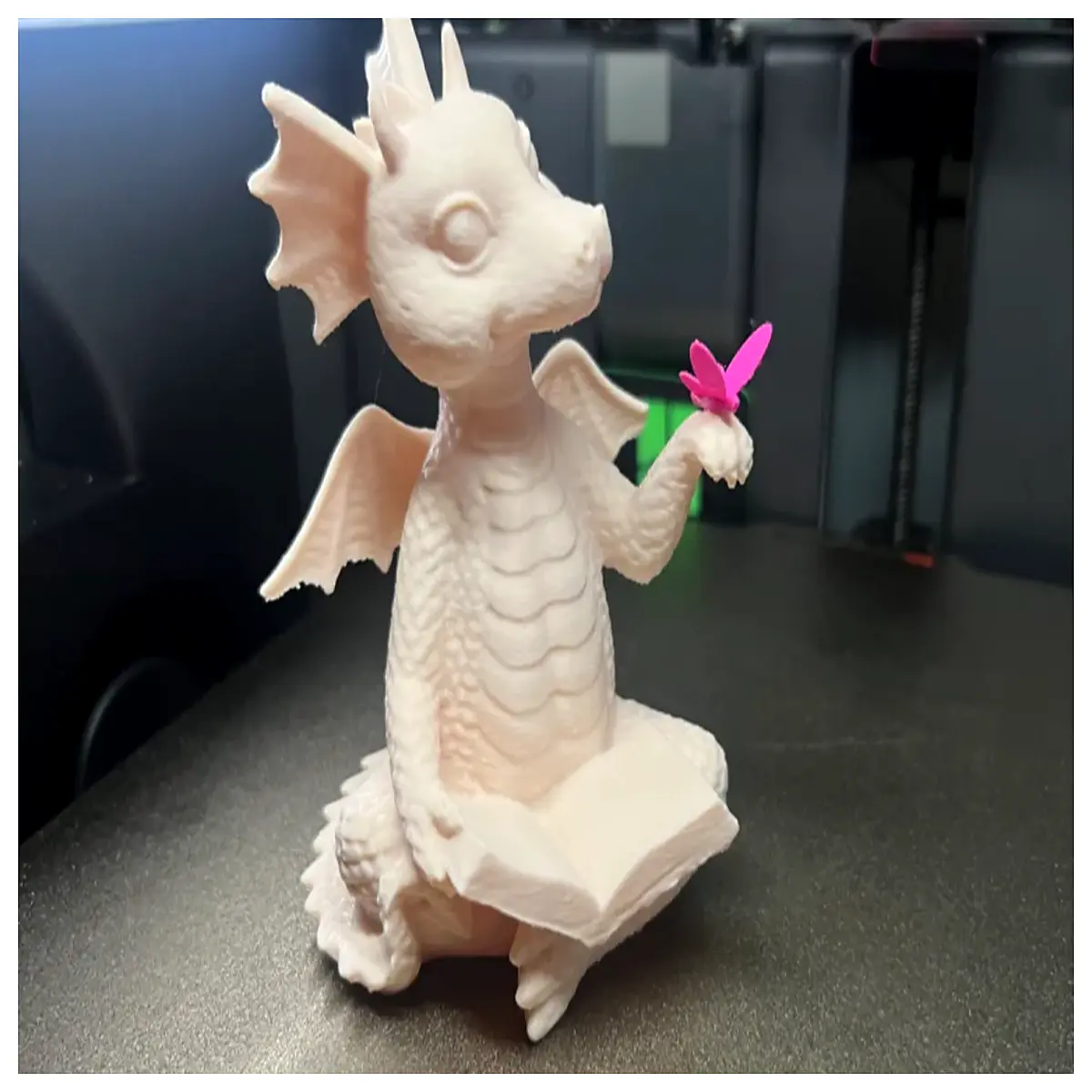 hand holding book dragon ornament fantasy creature reading prop magical animal figurine for desk decor whimsical dragon with acces