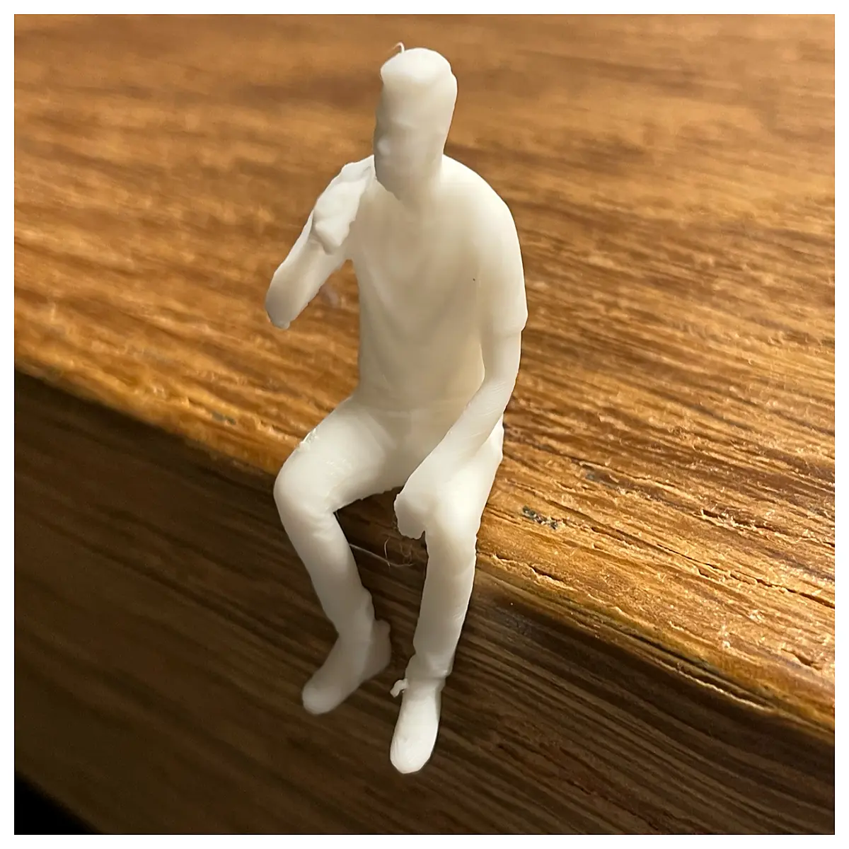 miniature figurine of man holding beer mug sitting down collectible resin statue for desk decor bar shelf