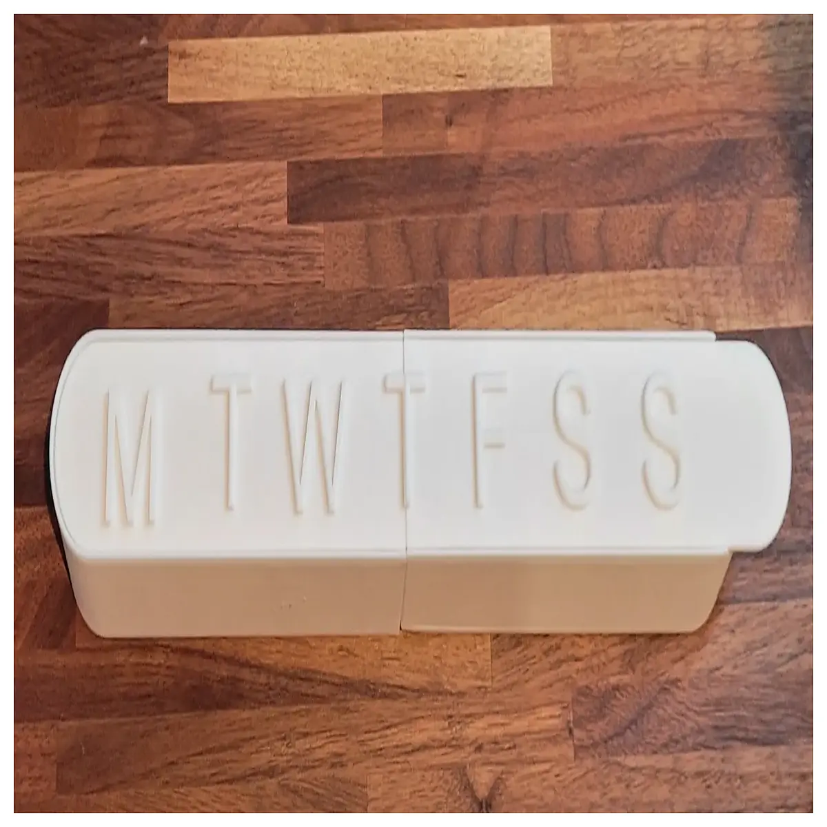 weekly pill organizer box with time slots for daily medication management and travel storage