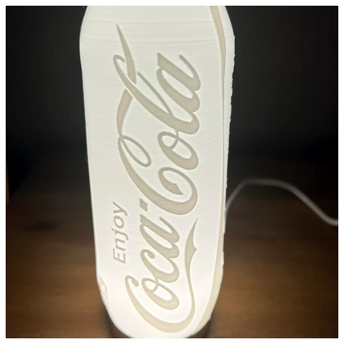 transparent glass coke can with embossed design