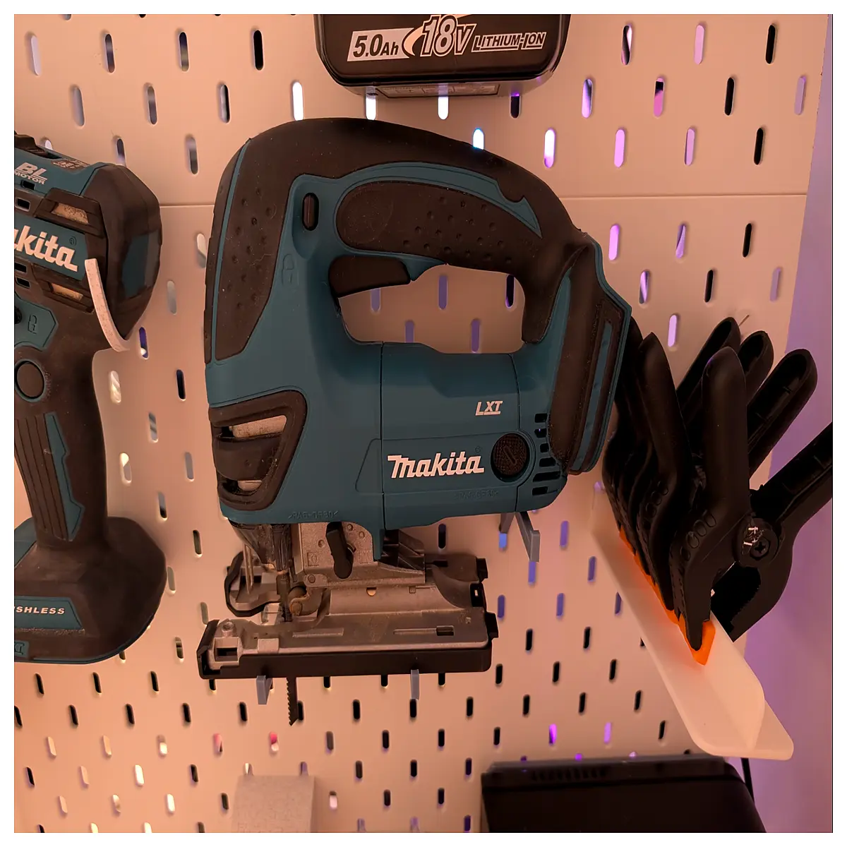makita 18v chainsaw holder pegboard storage hook for garage workshop organization tool rack