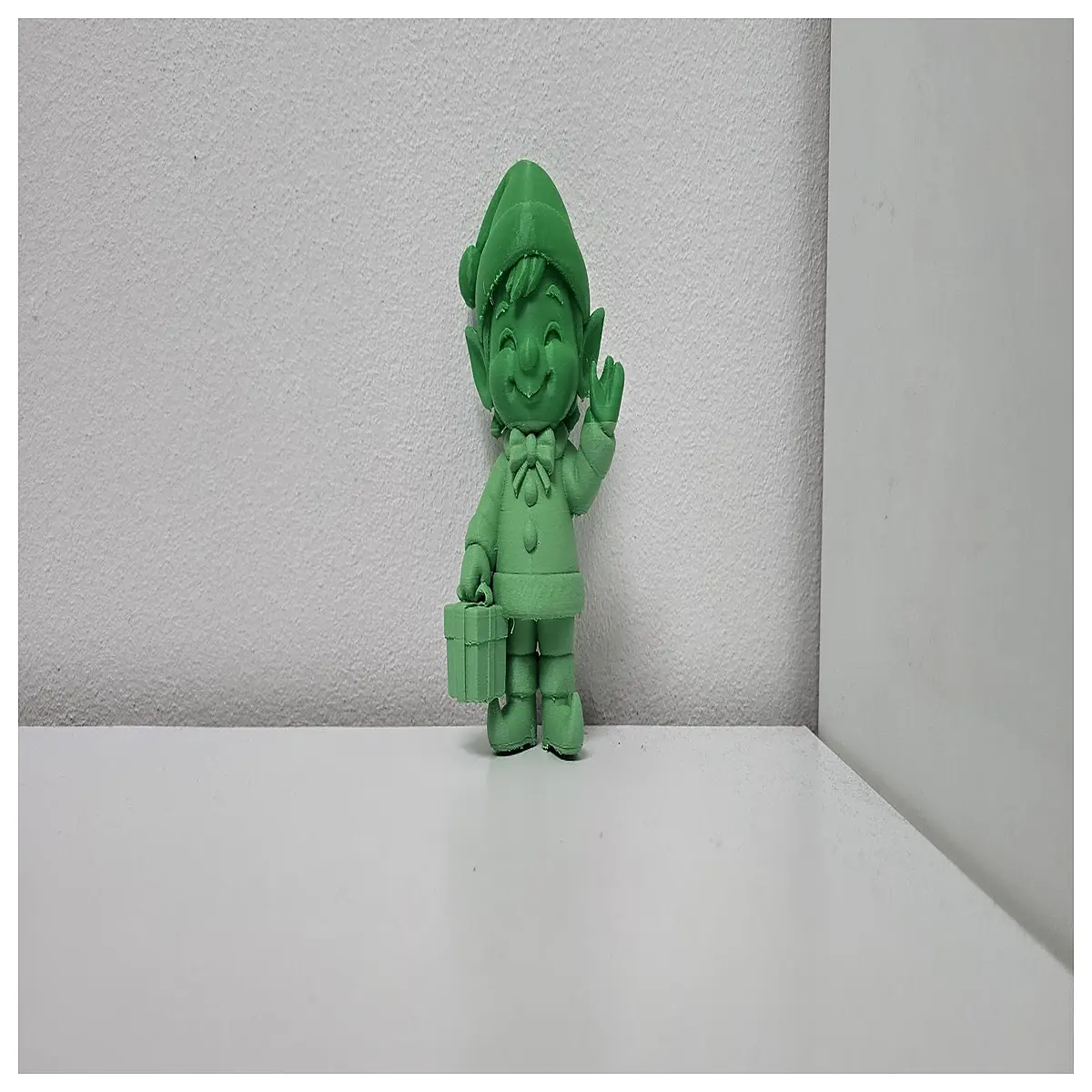 hand waving elf figurine with gift basket holiday decor